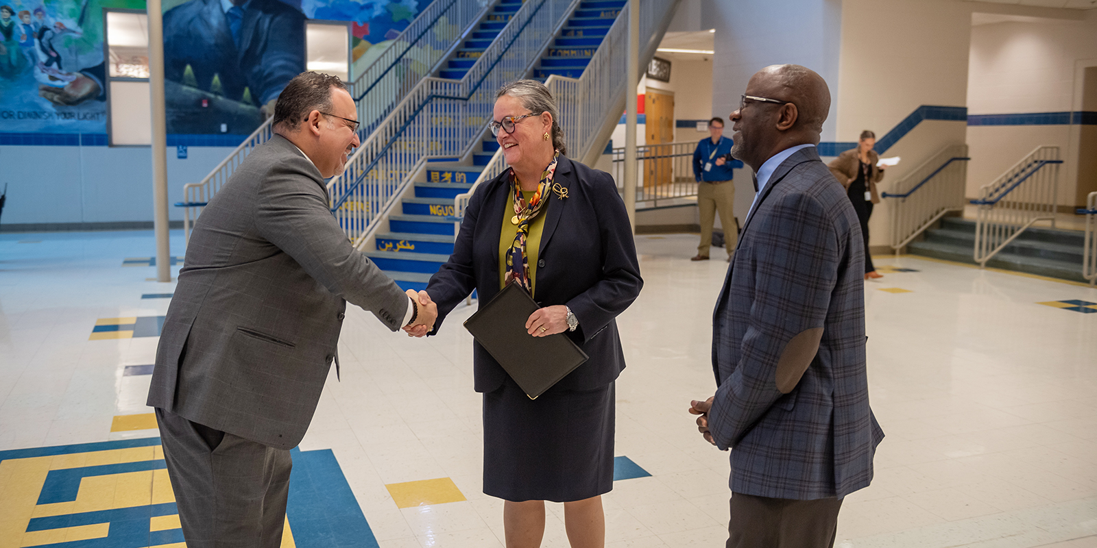 Lewis HS Principal Alfonso Smith and FCPS Superintendent Dr. Michelle Reid greet U.S. Education Sec. Miguel Cardona as he visits Lewis for a town hall on teen mental health.