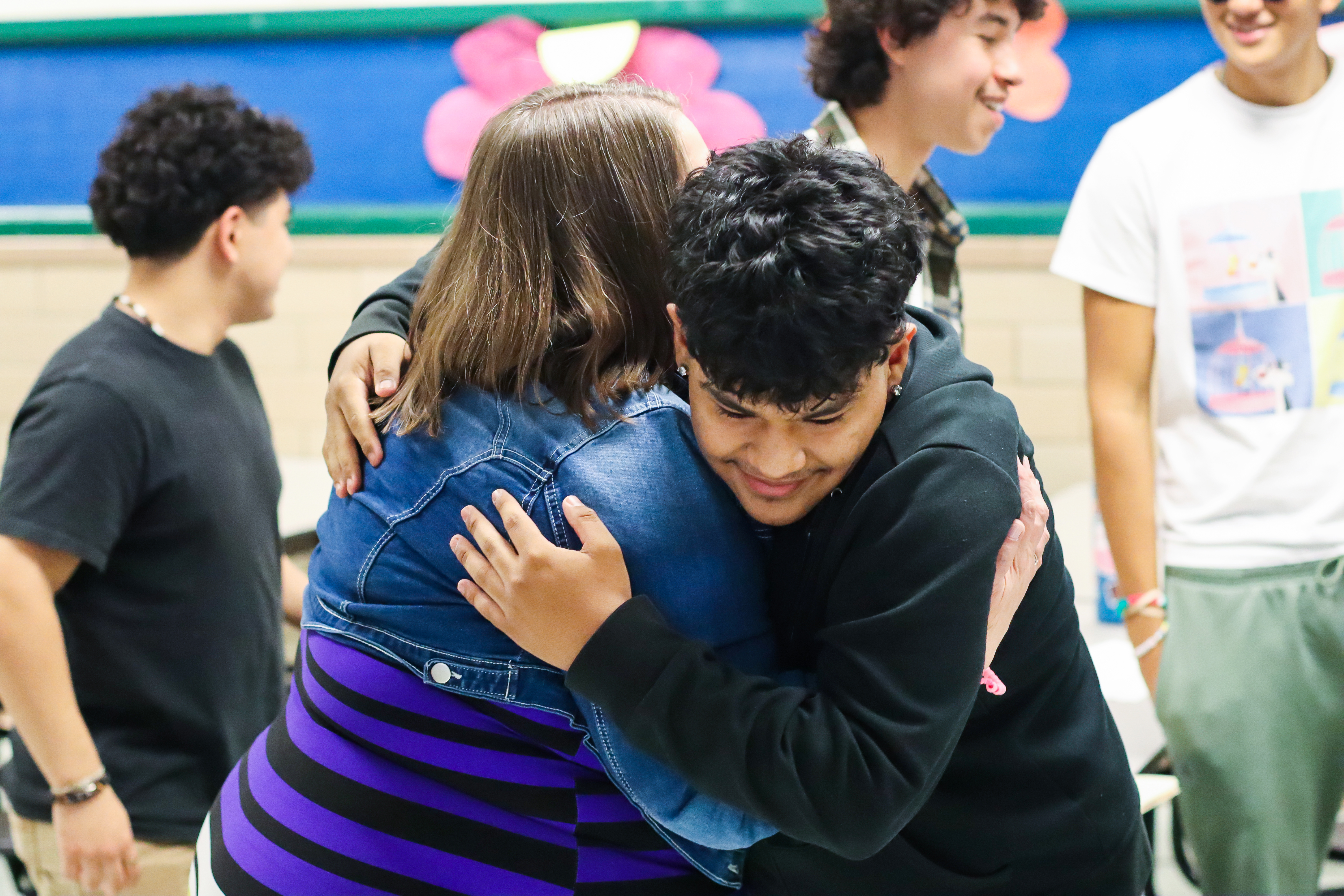A former Lynbrook Elementary student, now a Lewis High School grad, hugs their one-time sixth grade teacher Wendy Casual.
