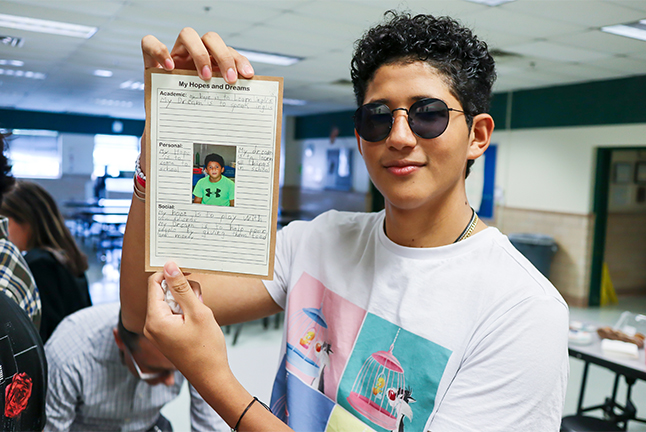 Former Lynbrook ES student Josue Delarca displays a letter he wrote in sixth grade to his future self, in which he dreams of being able to one day speak English.